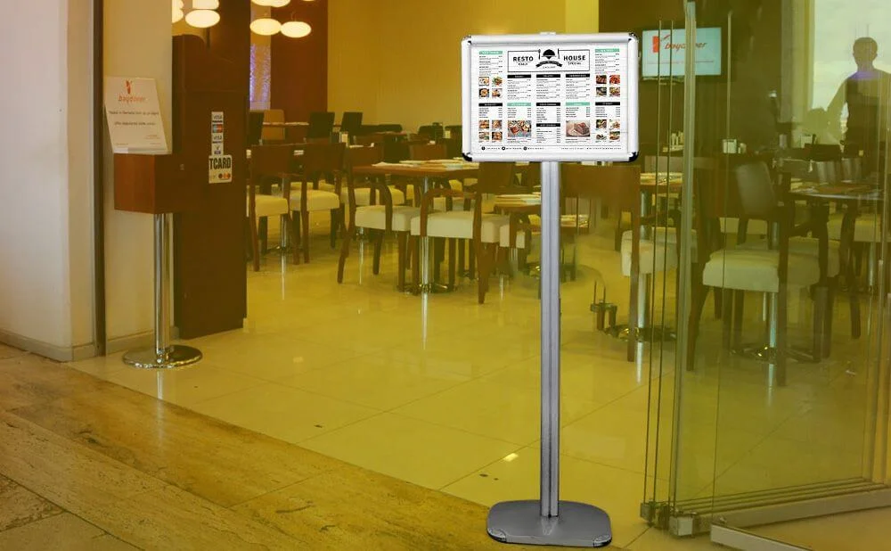 11-x-17-adjustable-menu-board-floor-sign-stand-1-silver-round-corner (3) 11x17 Adjustable Floor Menu Board & Floor Sign in front of a restaurant