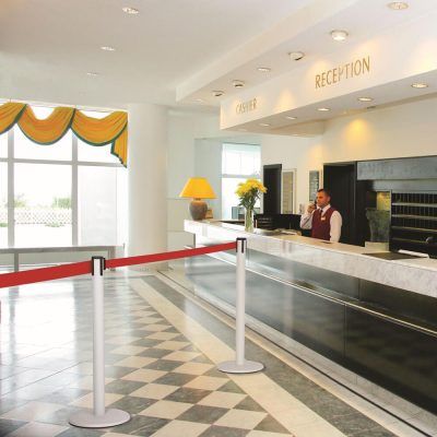 Red Retractable Stanchions in front of a reception desk