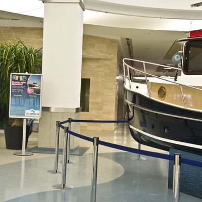 Blue retractable stanchion surrounding a display in a shopping mall