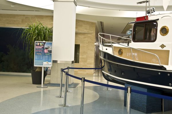 Blue retractable stanchion surrounding a display in a shopping mall