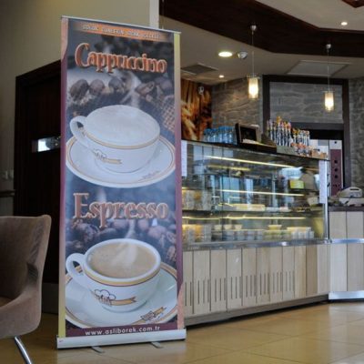 Large Smart Roll Banner that is advertising coffee in a small dining hall