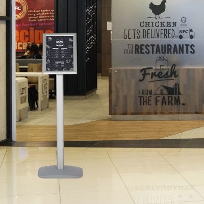 Adjustable Restaurant sign post in front of a restaurant in a shopping center