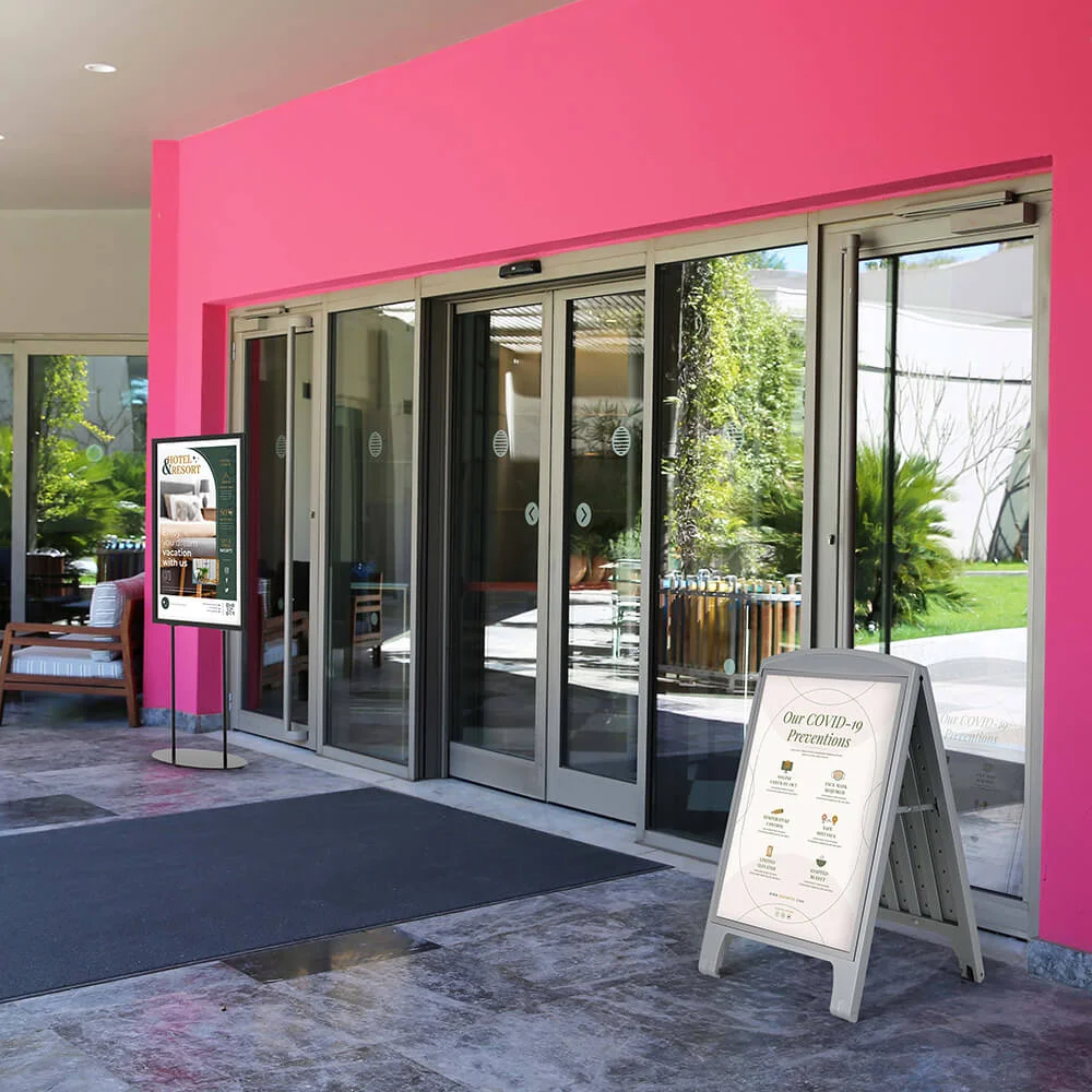 oval-poster-display Oval Based poster display stand outside of a pink building
