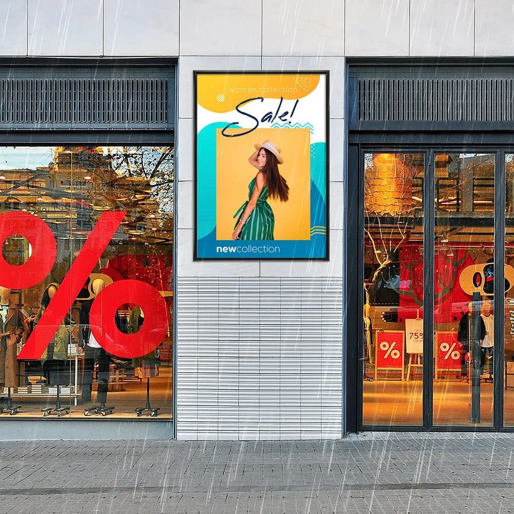 24x36-weatherproof-snap-poster Snap poster hanging in-between two windows of a clothing store that is advertising a sale on the new collection