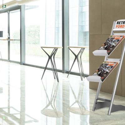 A two tiered brochure stand in the lobby of a hotel