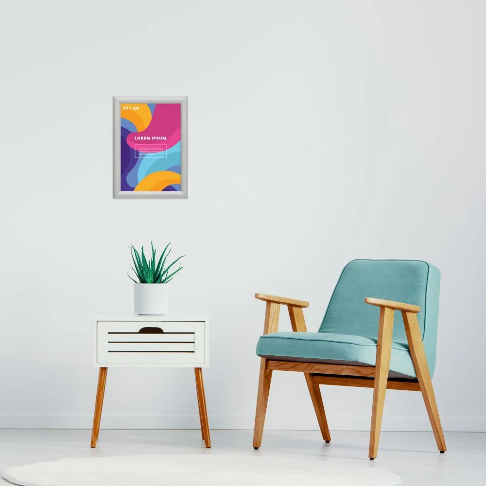 The use of this aluminum Small colorful poster hanging in a snap frame above a lounge area with a chair & a side table