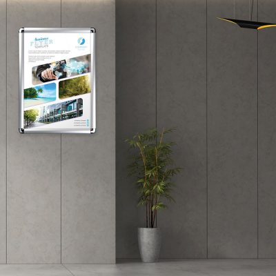 A rounded corner silver snap frame holding a flyer in the hallway of an office building