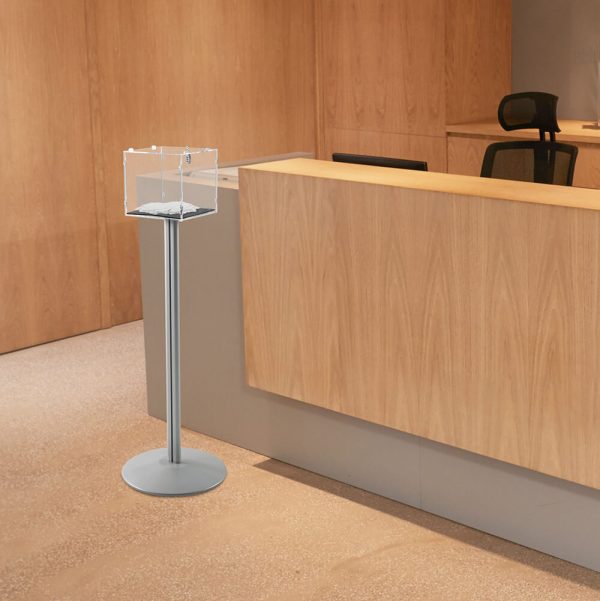 A floor standing ballot box in front of a desk