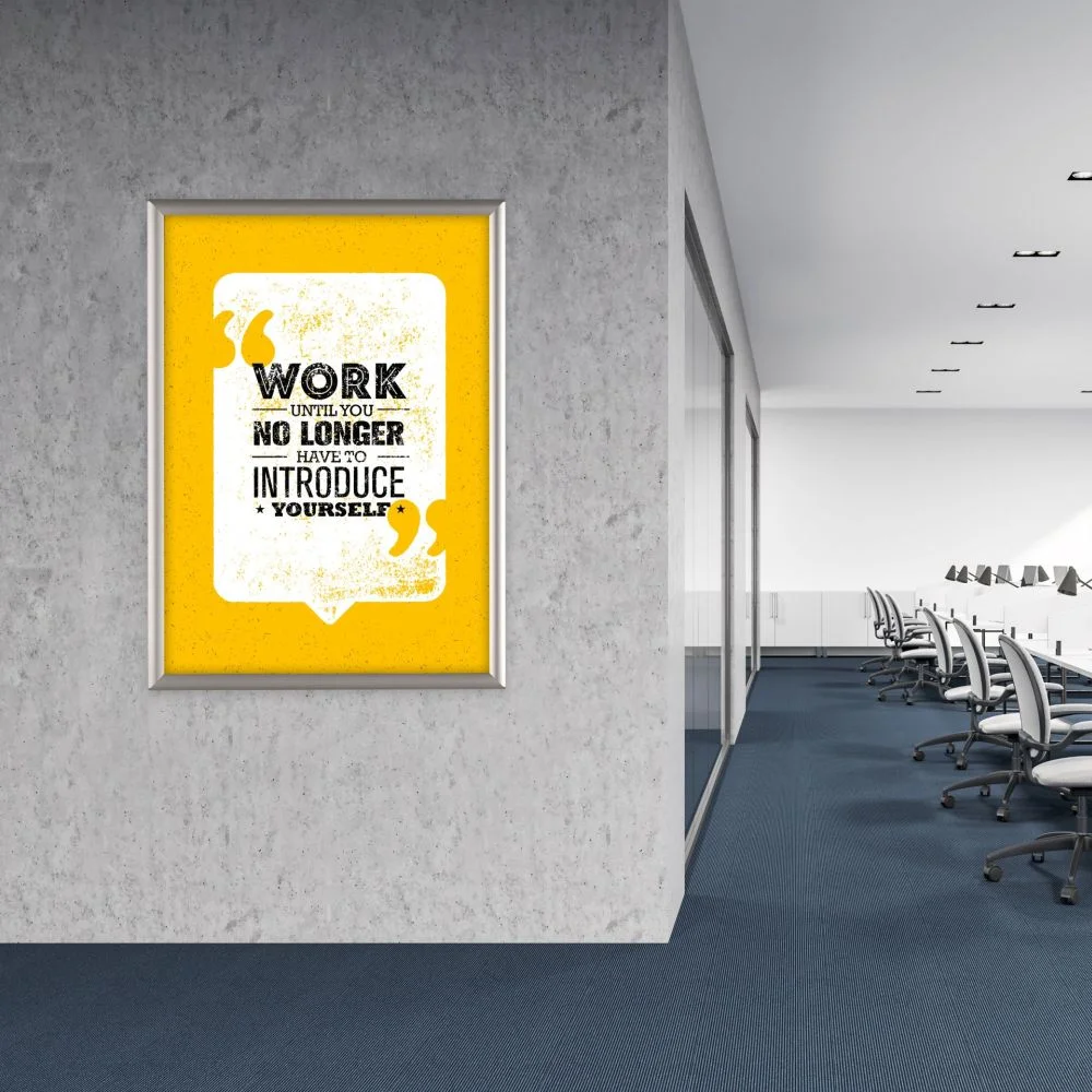 Opti Frames A1 Mitred A Silver opti frame hanging on the wall of an office building