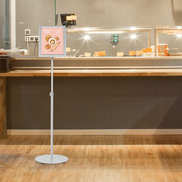 Adjustable Floor Sign Stand Holder in front of a deli counter