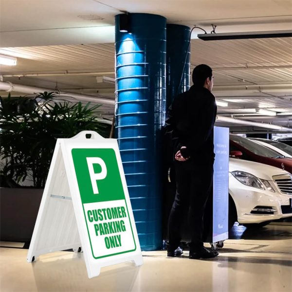 Customer Parking only sign on a white SignPro Sidewalk sign in a parking garage next to a valet