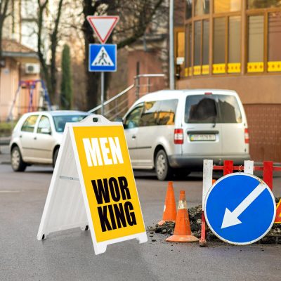 Men working sign on a white SignPro sandwich A Board