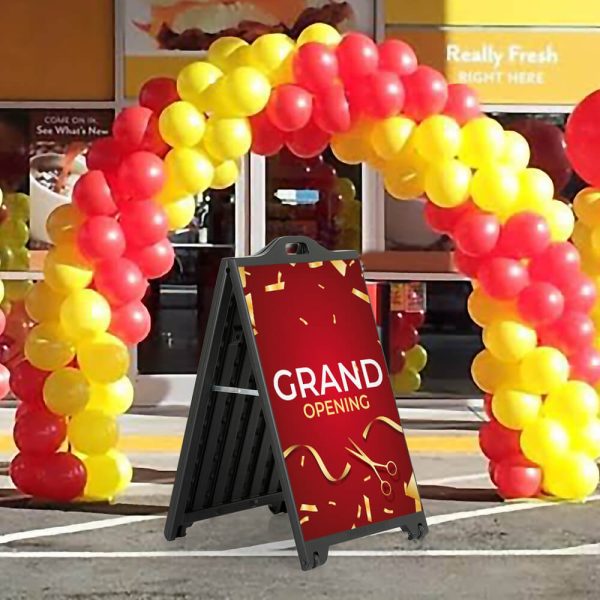 Grand Opening Sign on a SignPro Black A-Board Sidewalk Sign underneath a balloon arch outside of a brand new restaurant