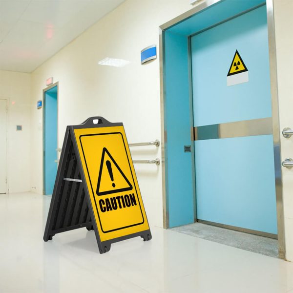 Caution Sign on a Black A-Frame SignPro Sidewalk Sign outside of a hazardous room in a hospital