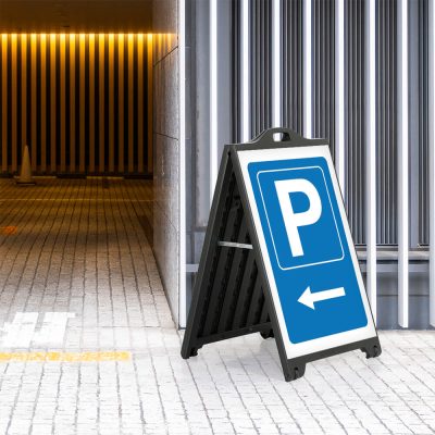 Parking Left sidewalk sign outside of a parking garage