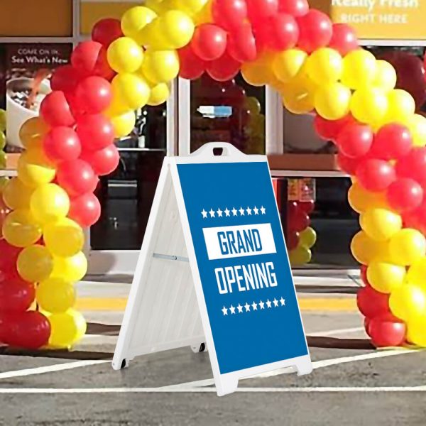 Grand Opening sign on a white SignPro Sidewalk sign under a balloon arch outside of a brand new restaurant