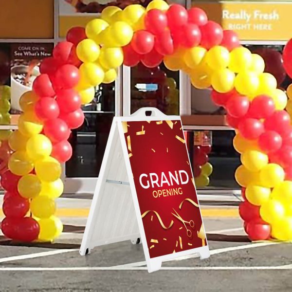 Grand Opening sign on a white SignPro Sidewalk sign under a balloon arch outside of a brand new restaurant