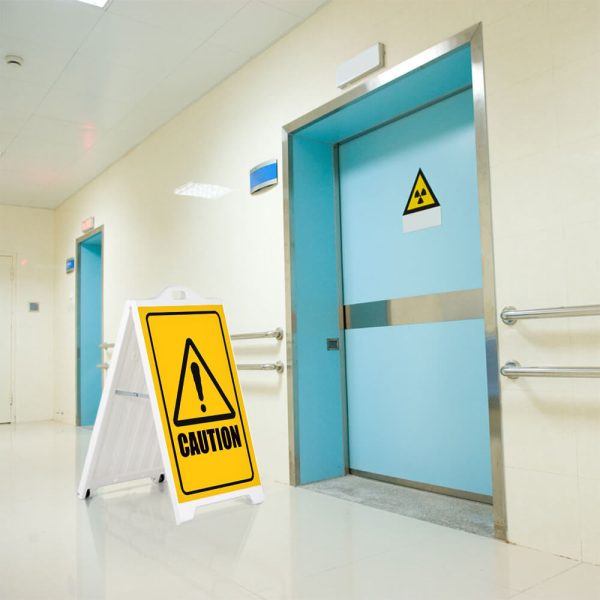 Caution sign on a SignPro Sidewalk sign outside of a hazardous room in a hospital