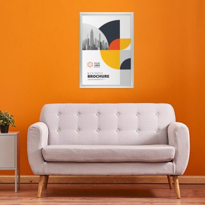 Snap Frame Holding a businesses poster hung on an orange wall above a pale pink couch