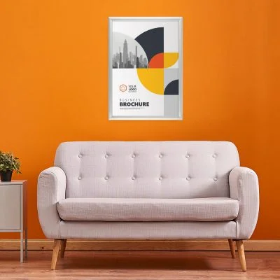 Snap Frame Holding a businesses poster hung on an orange wall above a pale pink couch