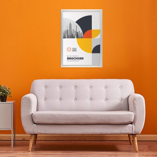 Snap Frame Holding a businesses poster hung on an orange wall above a pale pink couch