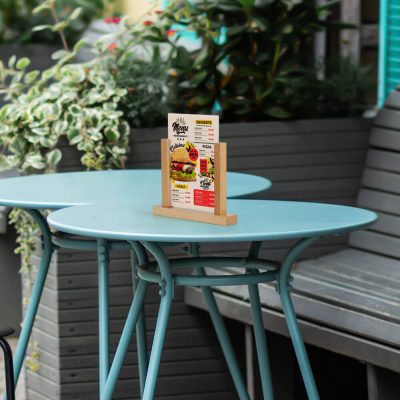 Desk top menu holder on top of a blue bistro set