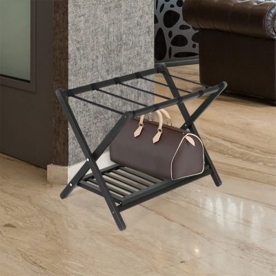 Black Beech Wood Folding Luggage Rack Next to a Couch with a Duffel bag on it