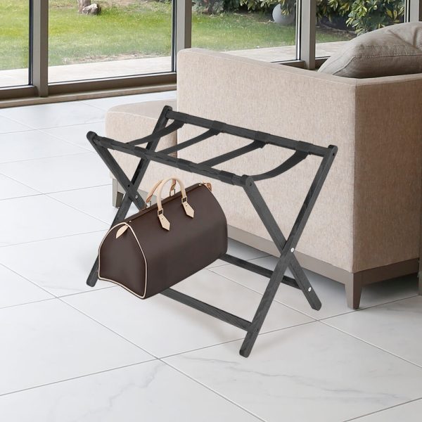 Black Beech Wood Folding Luggage Rack Next to a Couch with a Duffel bag on it