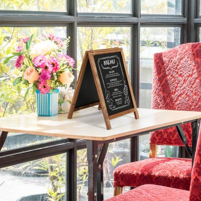 Nature Line Fir Wood Tabletop Mini A Board with Chalkboard on a table in a small cafe