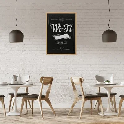 wifi password written out on a framed chalkboard hanging on the wall in a small cafe