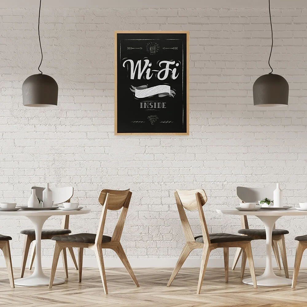 wifi password written out on a framed chalkboard hanging on the wall in a small cafe