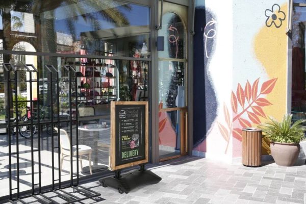 WindPro Pavement Sidewalk Sign with magnetic Chalkboard outside of a cafe