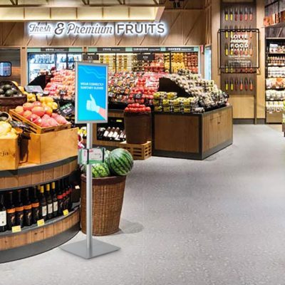 Floor Standing healthcare glove box holder with Opti Frame in front of the produce section of the grocery store