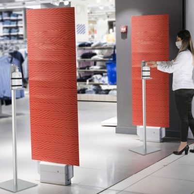 Floor Standing Pump Hand Sanitizer Dispenser in front of a clothing shop in a shopping mall