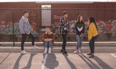 teenagers socializing in a parking lot