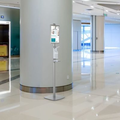 a floor standing hand sanitizer dispenser in a shopping center