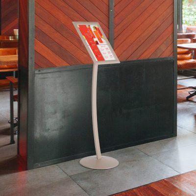 Large Pale rose floor standing menu board in a restaurant