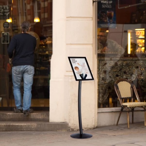 Curved menu board holding a coffee menu outside of a coffee shop