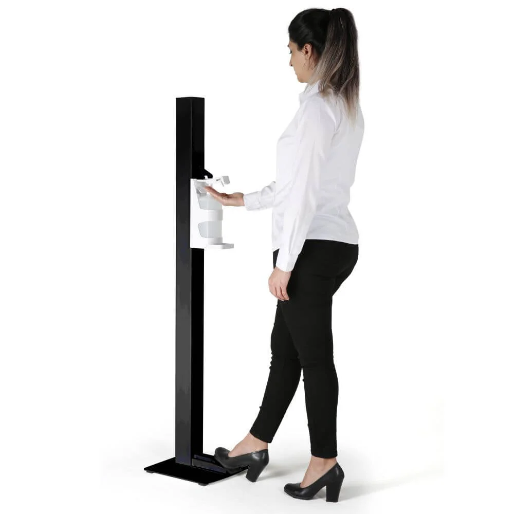 basic-touchless-hand-sanitizer-dispenser-1000-ml-33-8-oz-black-manual-foot-operated (1) A woman getting hand sanitizer from the black touchless hand sanitizer dispenser with foot pedal
