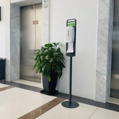 Floor Standing Automatic Touch Free Sensor Liquid Hand Sanitizer Dispenser with Dip Tray in front of elevators
