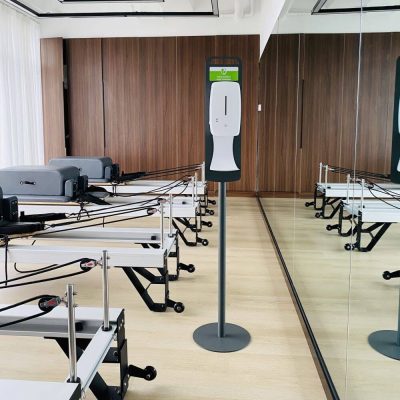 Floor Standing Automatic Touch Free Sensor Liquid Hand Sanitizer Dispenser with Dip Tray in a pilates room