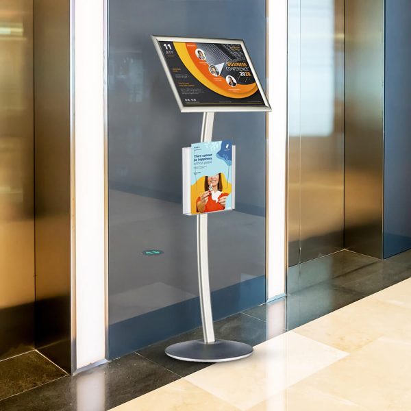 A pedestal sign holder in between two elevators