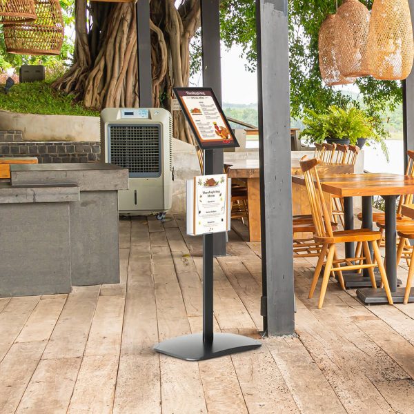 A menu board in an outside seating section of a restaurant