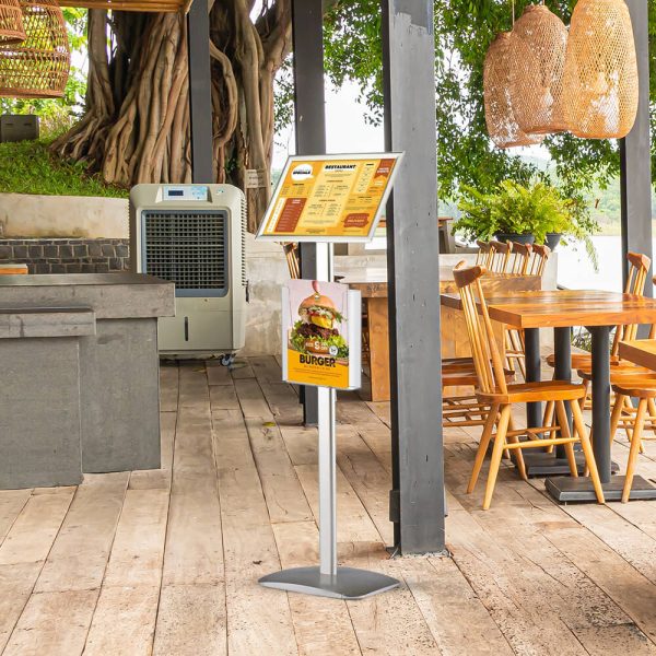 A menu board in an outside seating section of a restaurant