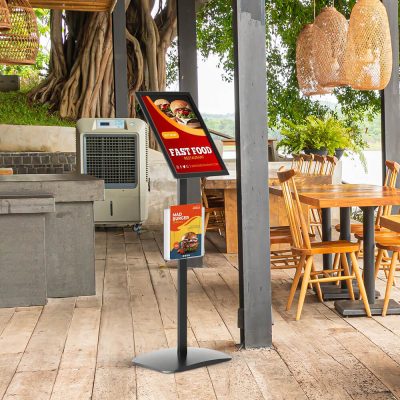 A menu board in an outside seating section of a restaurant