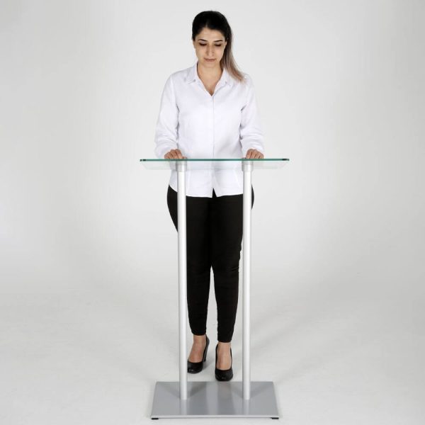 Woman standing behind a Silver tempered glass podium