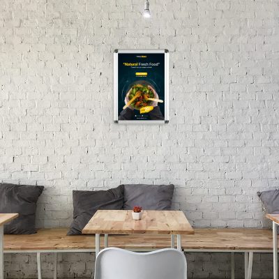A food poster hanging above seating in a small cafe