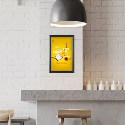 A poster hanging in a Slide in Frame on a white brick wall in a minimalist style restaurant