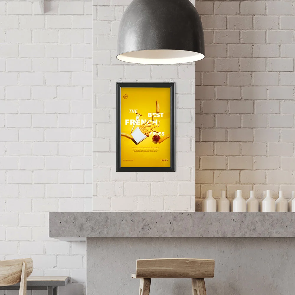8-5x11-slide-in-frame-1-inch-black-mitered-profile-double-sided-2-pack A poster hanging in a Slide in Frame on a white brick wall in a minimalist style restaurant
