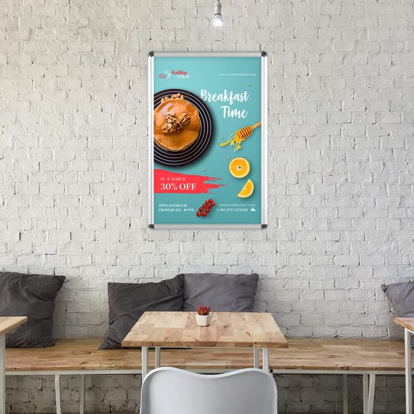 A breakfast poster hanging above seating in a small cafe
